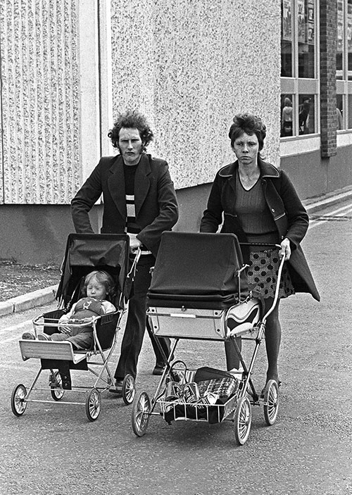Family leaving a shopping precinct Bromsgrove  (1975)