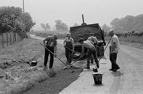 ex farm workers repair the road, Wichenford Worcs  (1969)