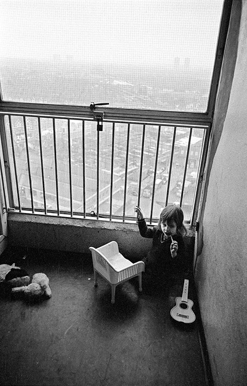 Child in her play area in the stairwell of the 13th floor of a tower block, Leytonstone  (1974)