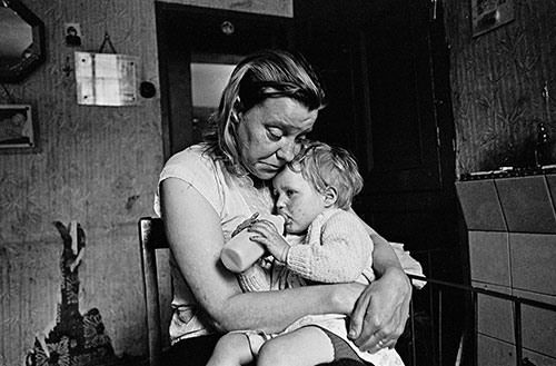 Mrs T and her youngest child, living without electricity or gas, Sheffield  (1969)