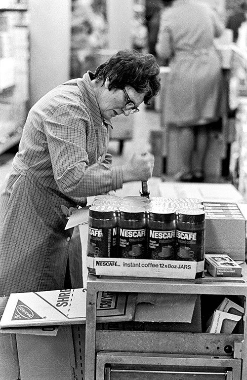 Worker pricing products, supermarket Birmingham  (1975)