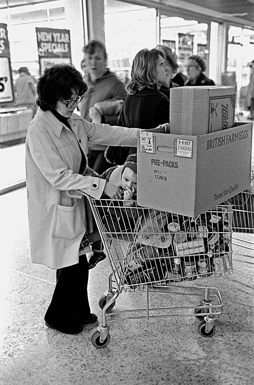 Mother and toddler after finishing a supermarket shop, Birmingham  (1975)