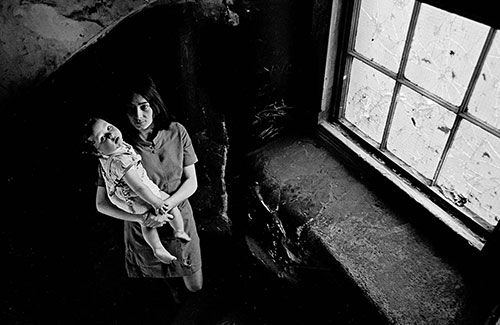 Mother and baby on the staircase to their Gorbals tenement flat, Glasgow  (1969)