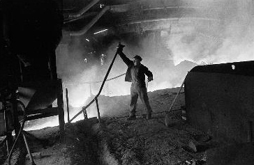 Photograph of man working in foundry